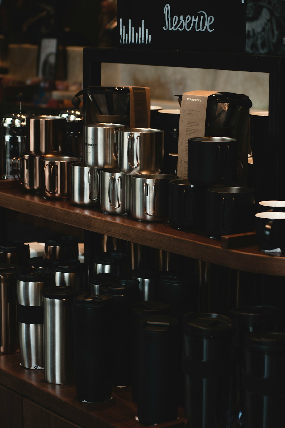 shallow focus photo of stainless steel containers on brown wooden surface