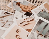 Collection of various semi-jewelry pieces with photo engravings arranged artfully on a white surface.