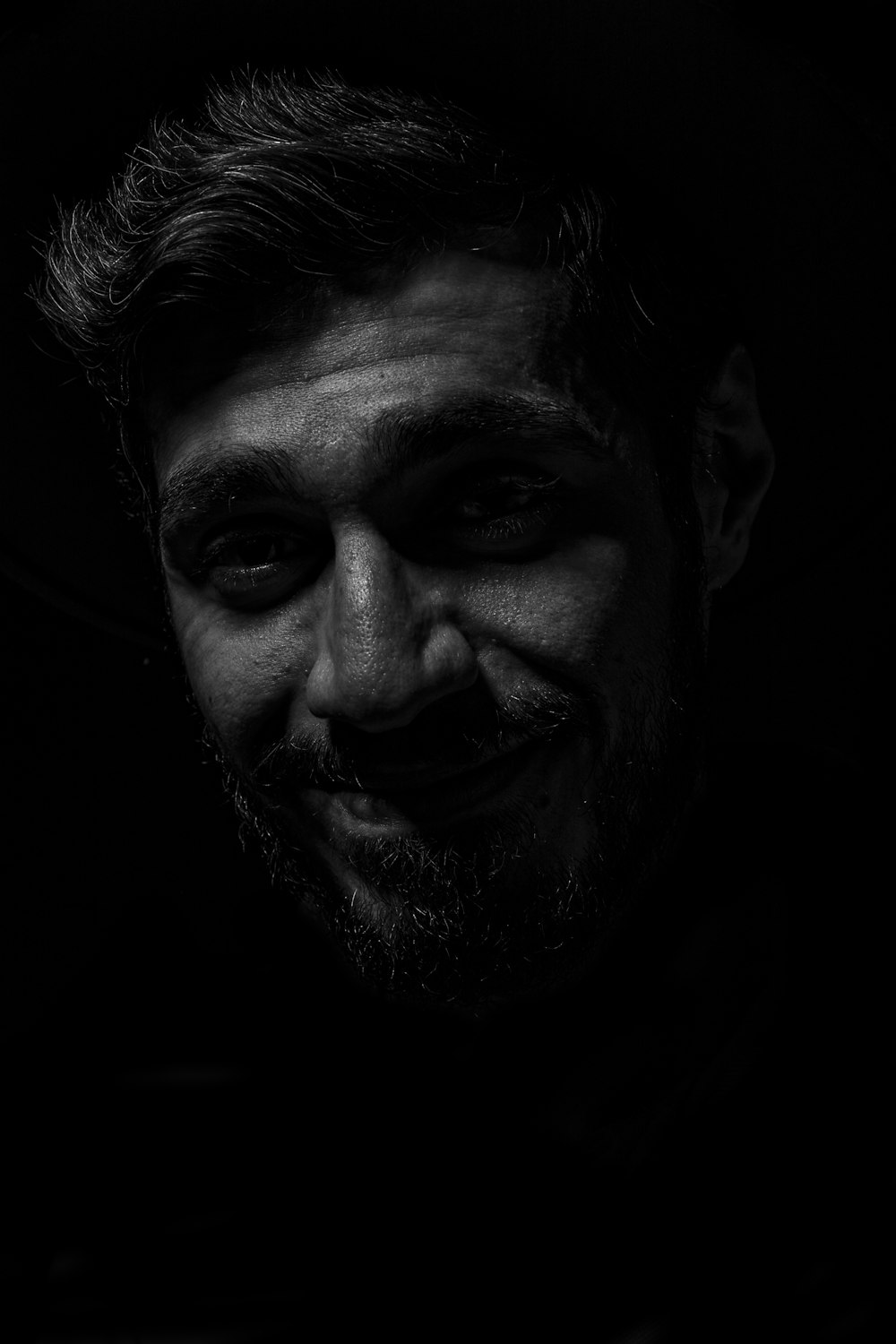 grayscale photography of smiling man