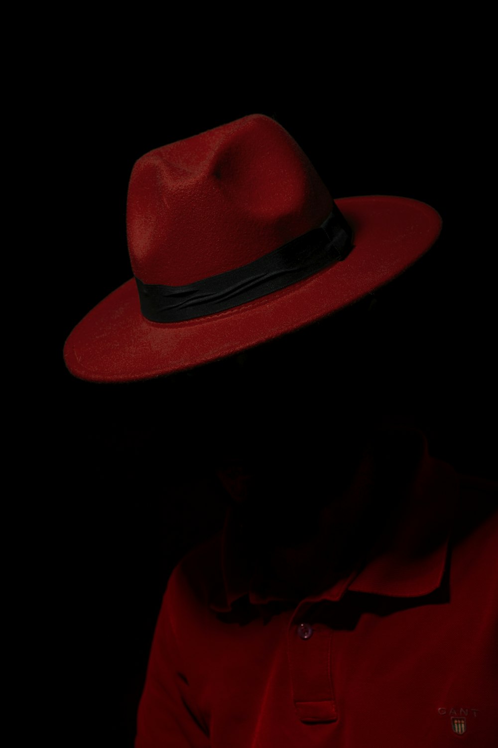 man wearing red polo shirt and red trilby hat