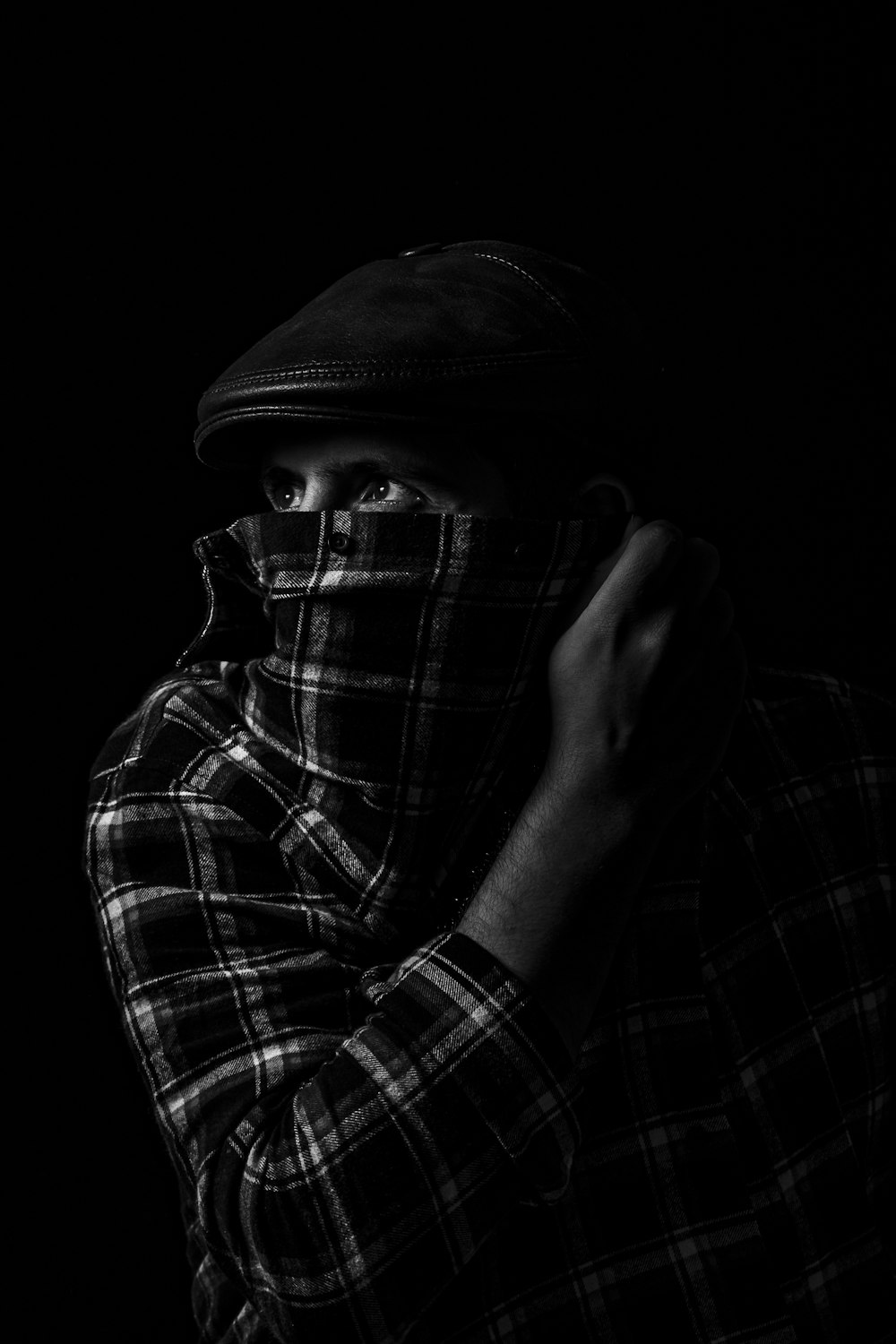 grayscale photography of man hiding face