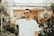 man in white crew-neck shirt wearing sunglasses standing near plants