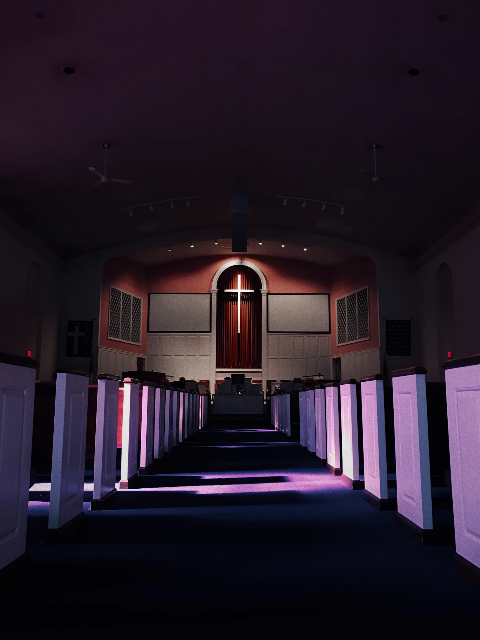 Rows of empty pews in a quiet church sanctuary