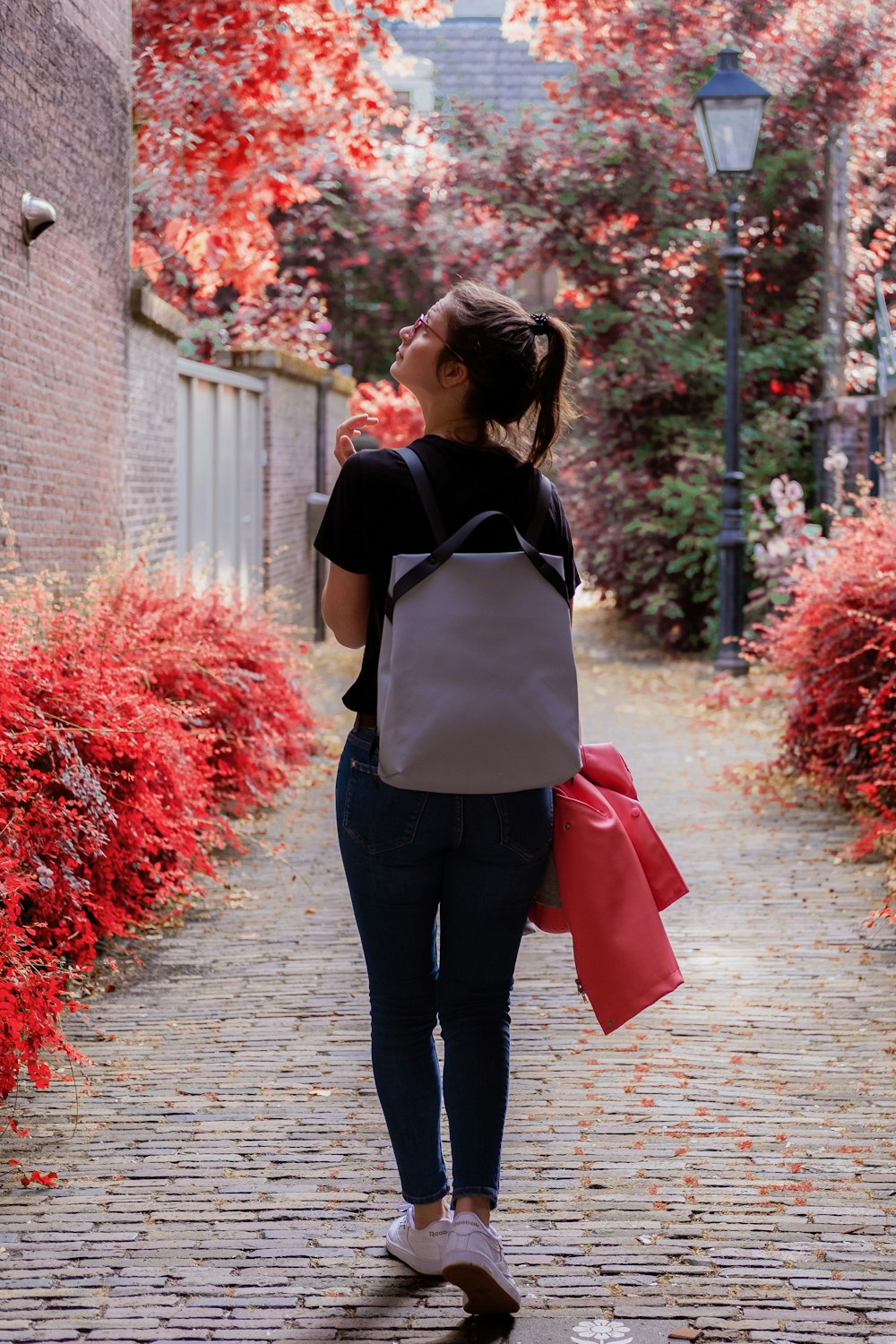 woman wearing black shirt and leggings carrying backpack