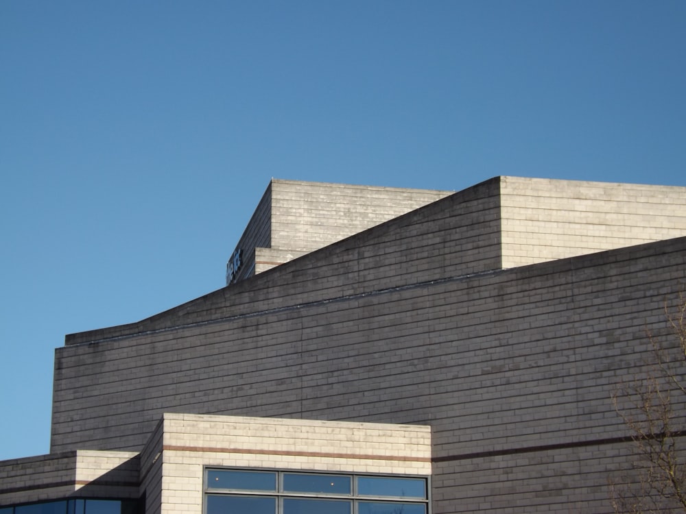 gray concrete building under a calm blue sky