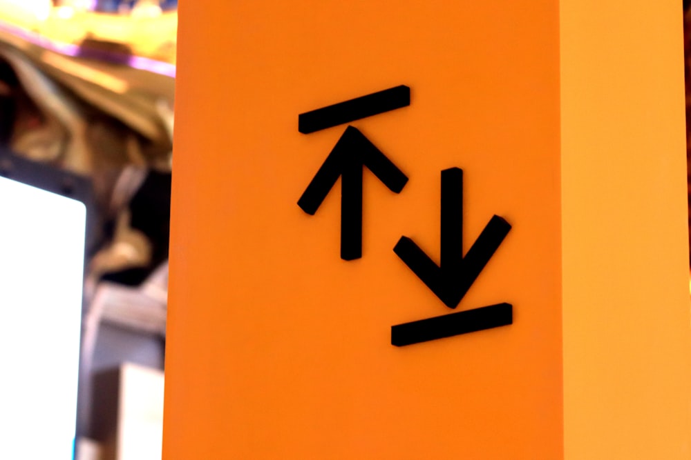 shallow focus photo of arrow up and down signage