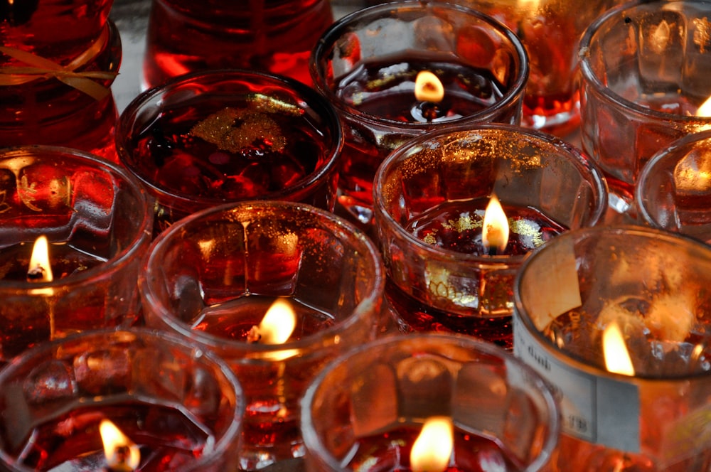 lighted candles in glasses