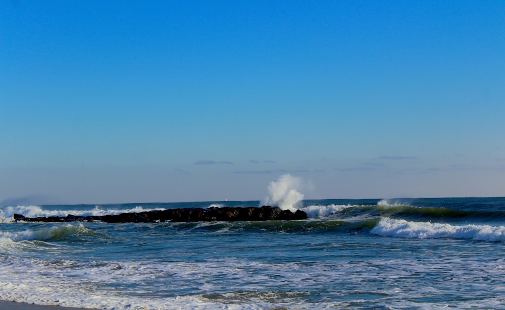 time lapse photography of blue waves splashing