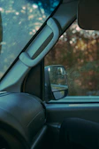 Interior vacuuming and wipe-down of a clean car cabin with natural light streaming in