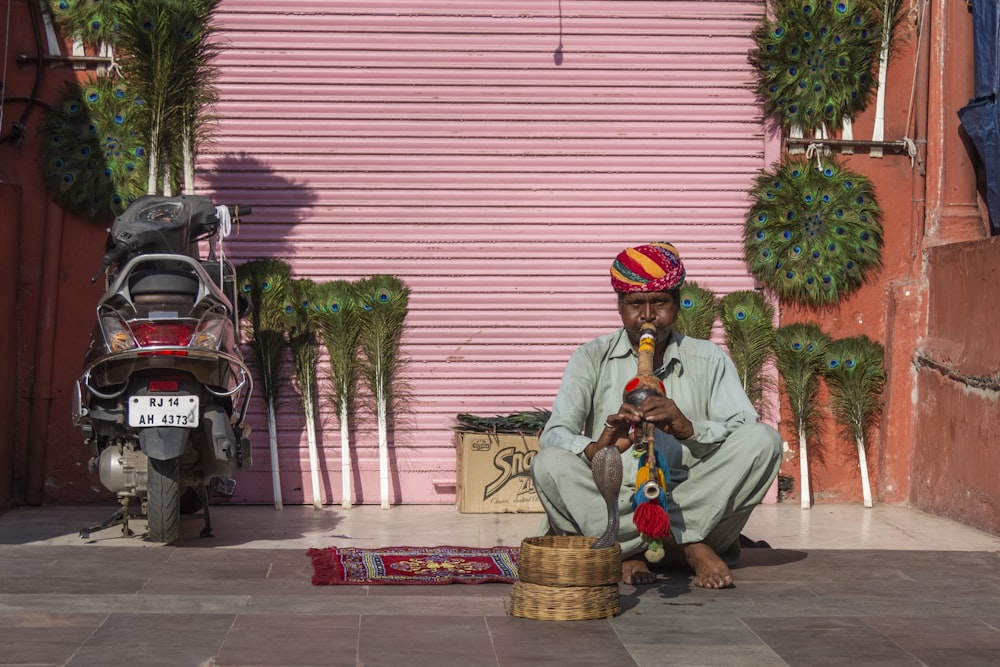 man wearing blue kurta playing flute