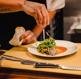 man standing front of plate with vegetable