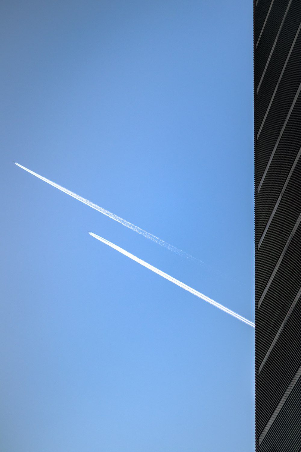 low-angle photography of two jet planes in the sky