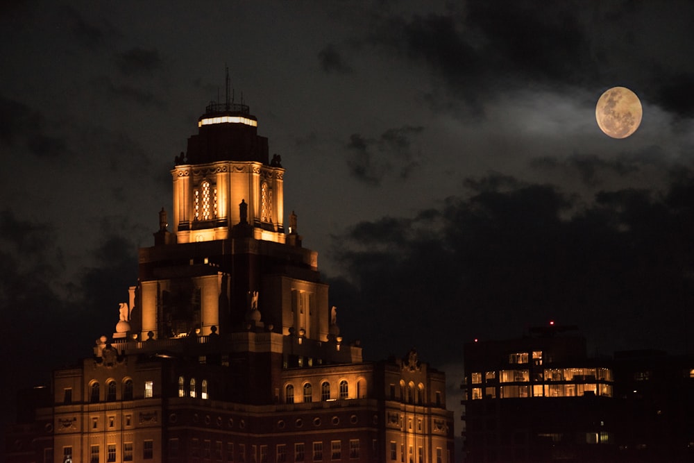 a very tall building with a clock tower at night