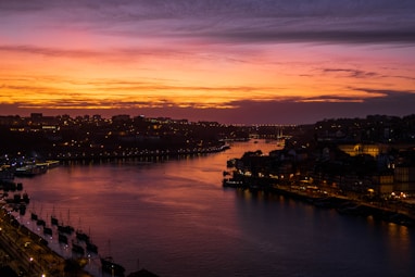 river between city buildings during golden hour