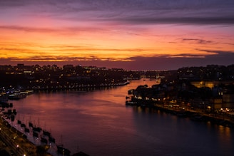 river between city buildings during golden hour
