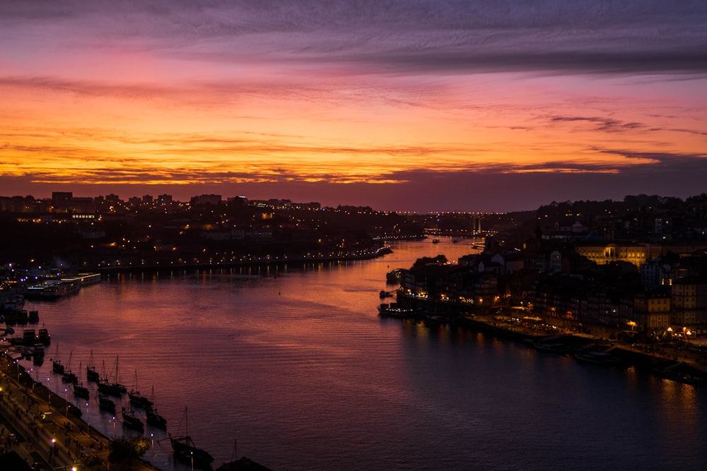 river between city buildings during golden hour