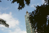 High-rise building framework rising against a deep blue sky, symbolizing strength and partnership.
