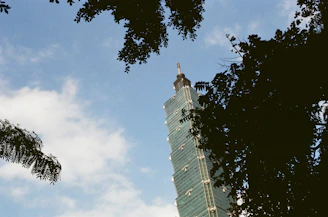 A striking vertical skyscraper silhouette against a clear sky, symbolizing growth and stability.