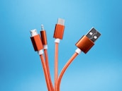 An array of colorful charging cables neatly organized on a white surface.