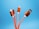 Four charging cables with orange braided coverings and various connectors, including USB and micro-USB, against a vibrant blue background.