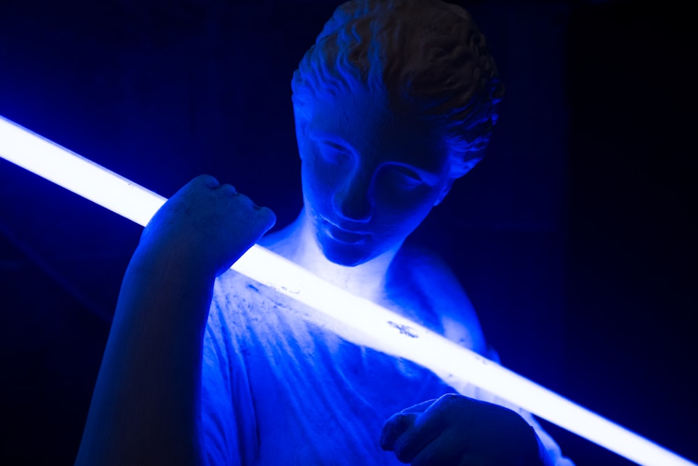 statue holding blue LED light