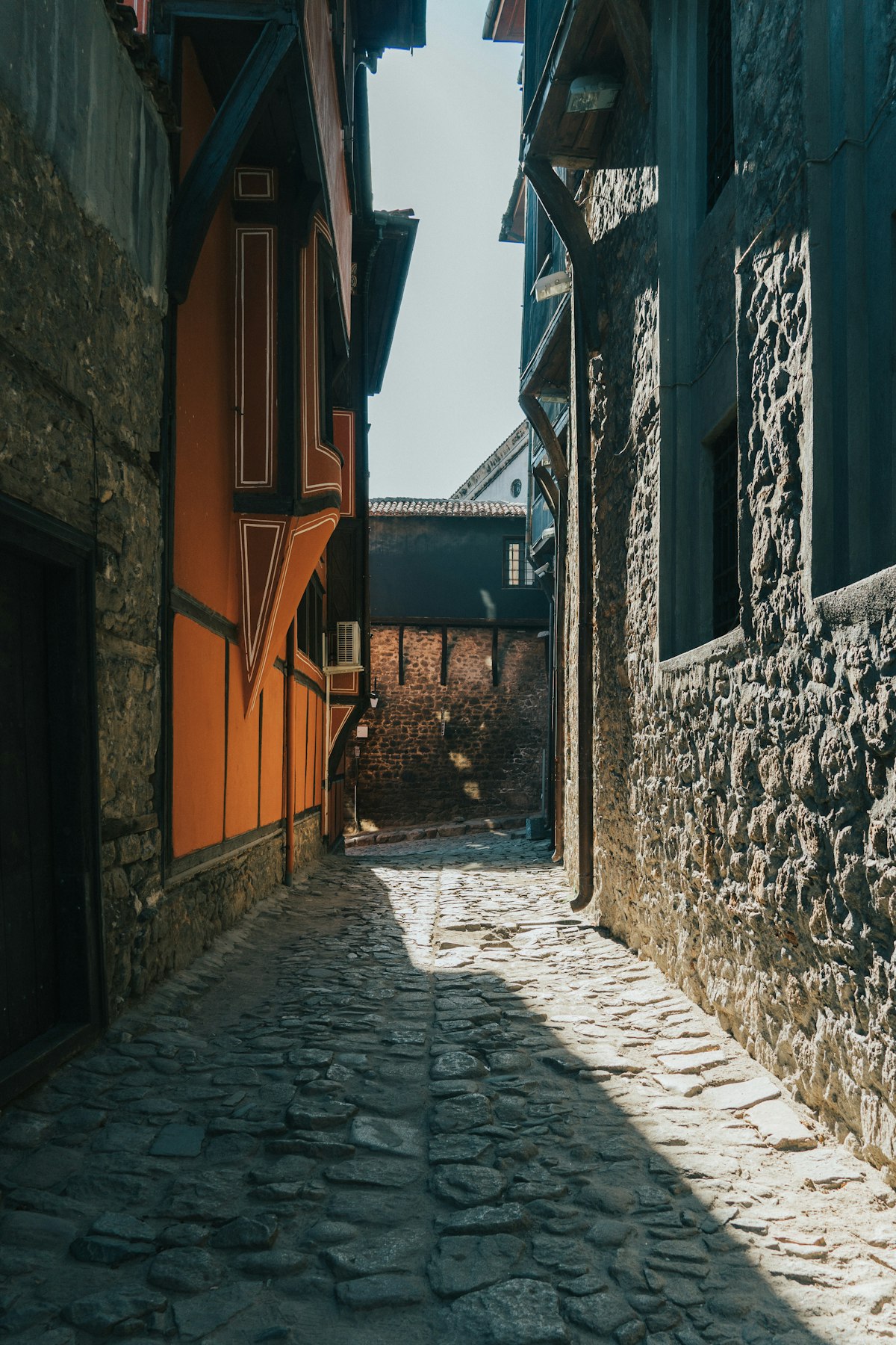 Plovdiv Old Town narrow cobblestone alley with colourful National Revival houses