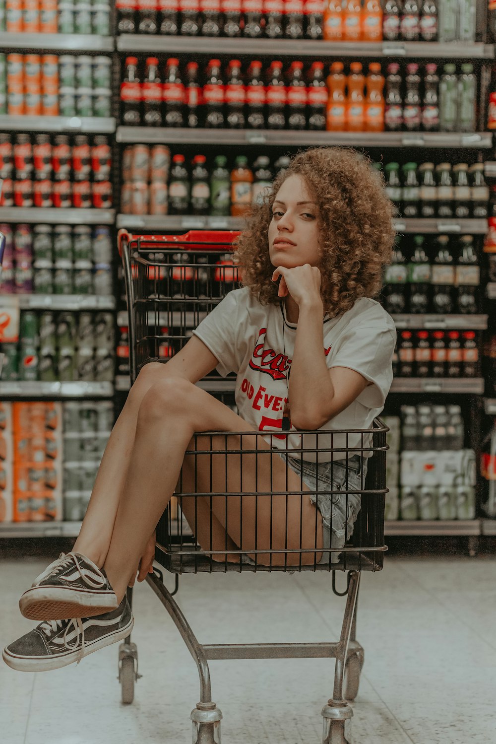 woman sitting in shopping cart