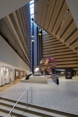 A panoramic view of the exhibition space highlighting intersecting geometric art pieces.