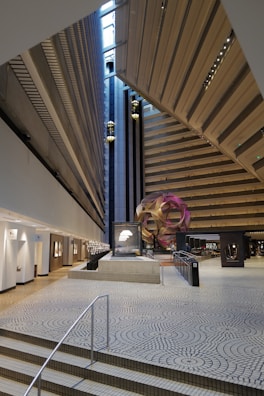 A panoramic view of the exhibition space highlighting intersecting geometric art pieces.
