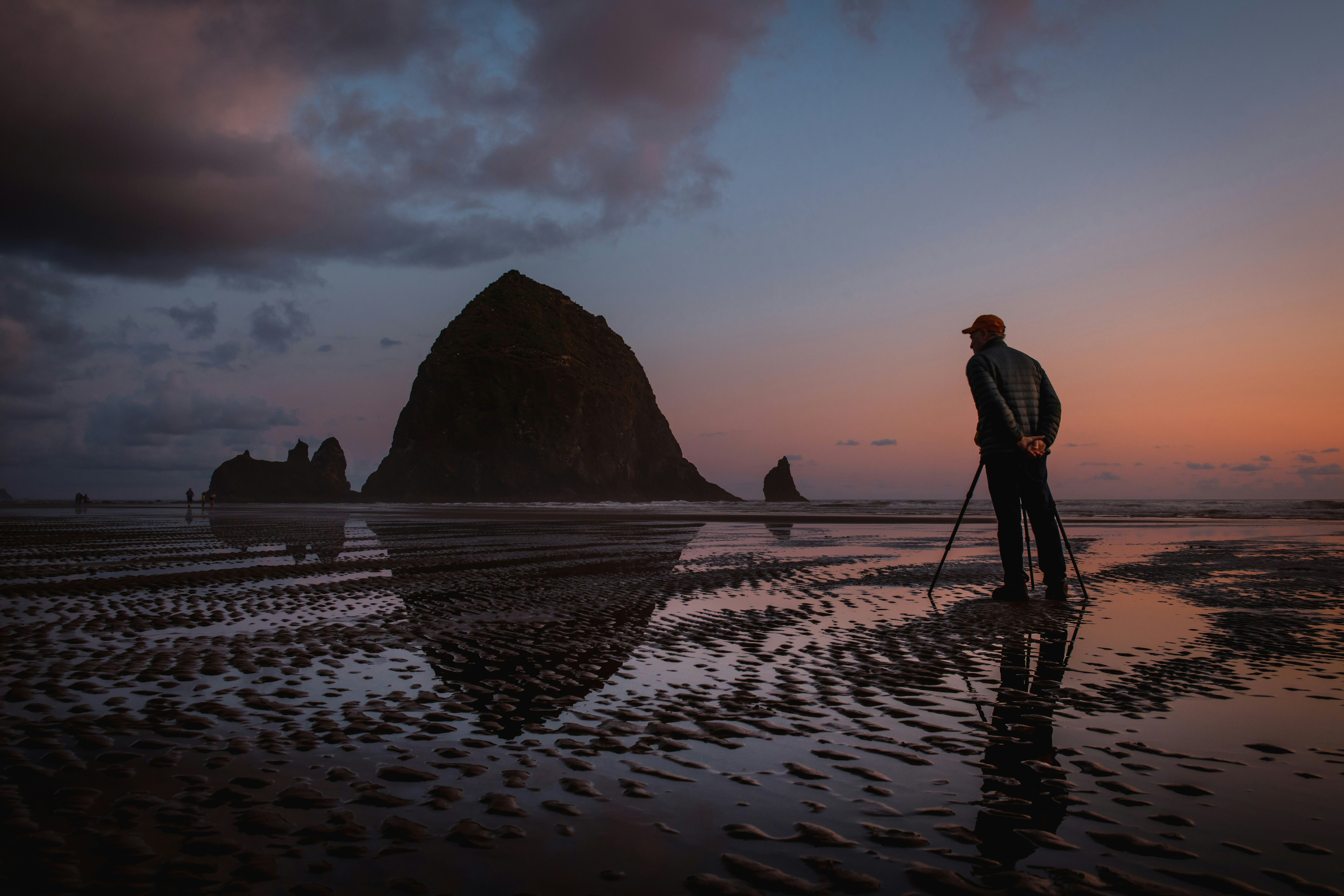 man standing on the seashore photograph