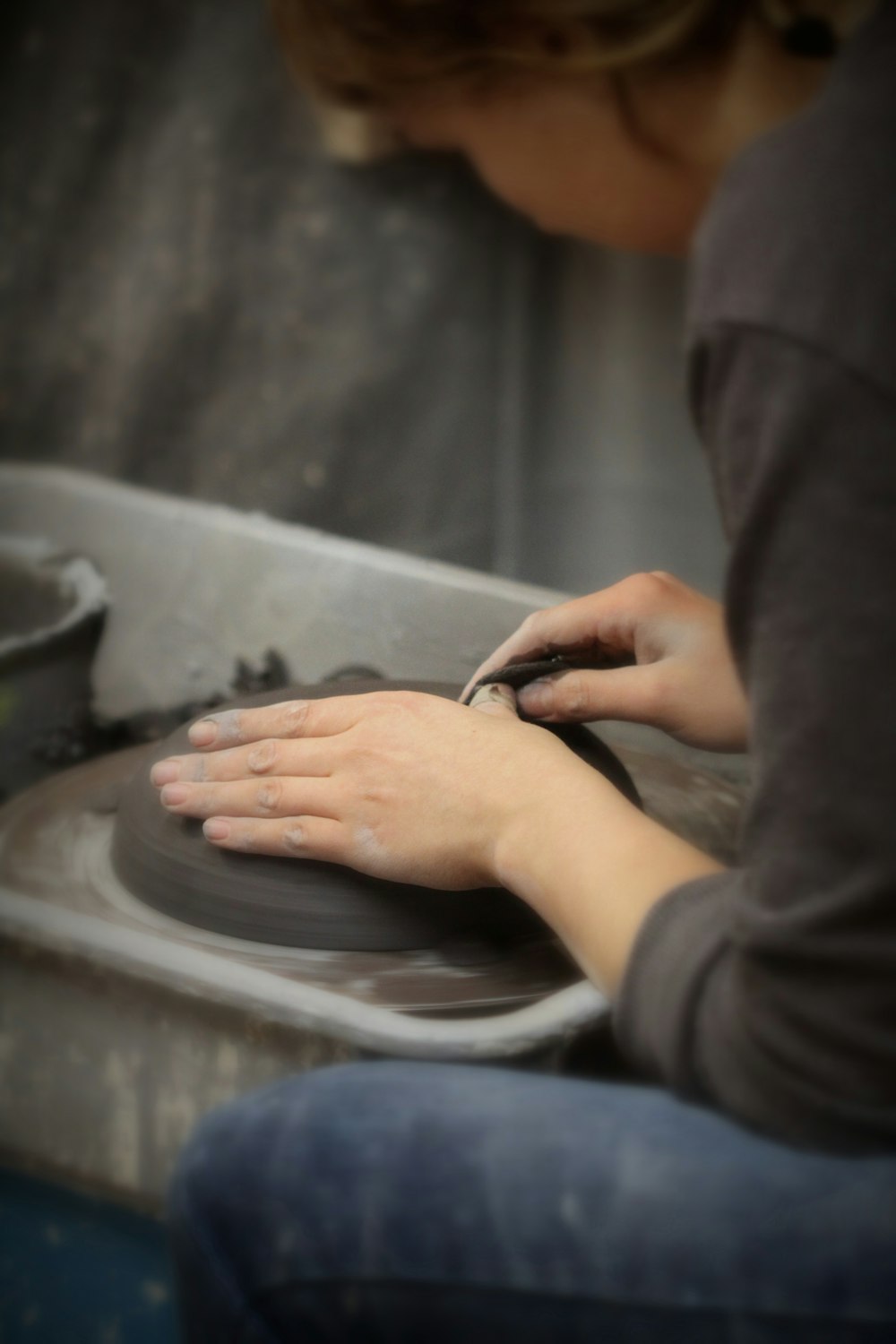 woman molding a clay
