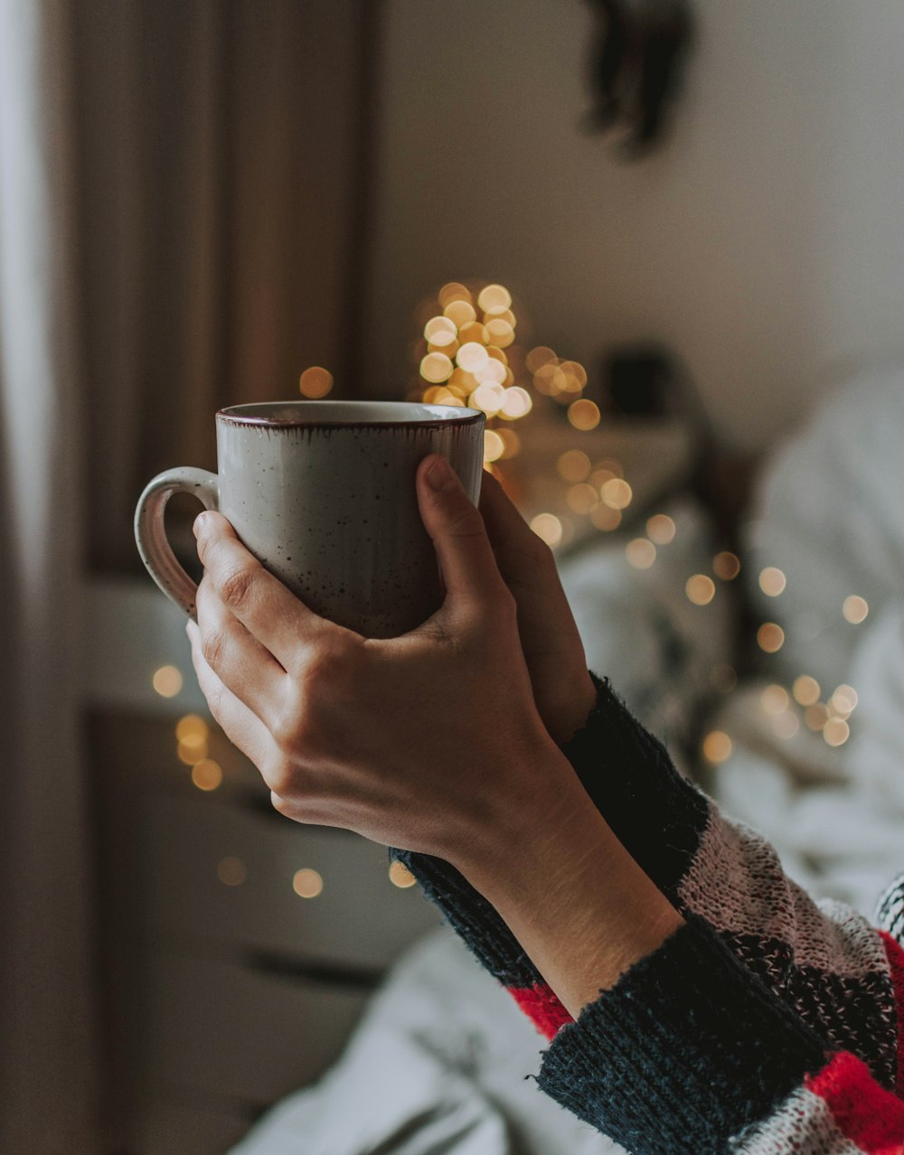 person holding gray ceramic mug