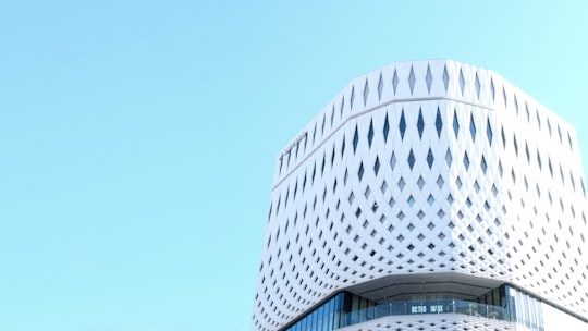 low angle photography of gray high-rise building in Kushiyaki Bistro Fukumimi Ginza Japan