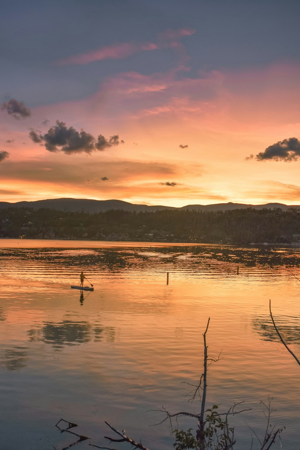 landscape photo of brown and black mountain behind body of water ]