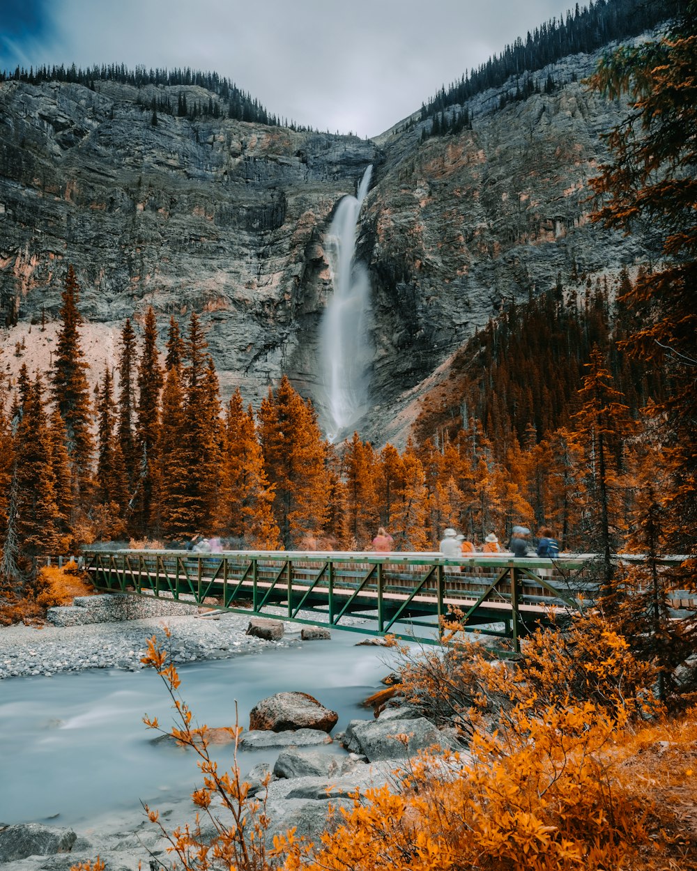 metal bridge near waterfall