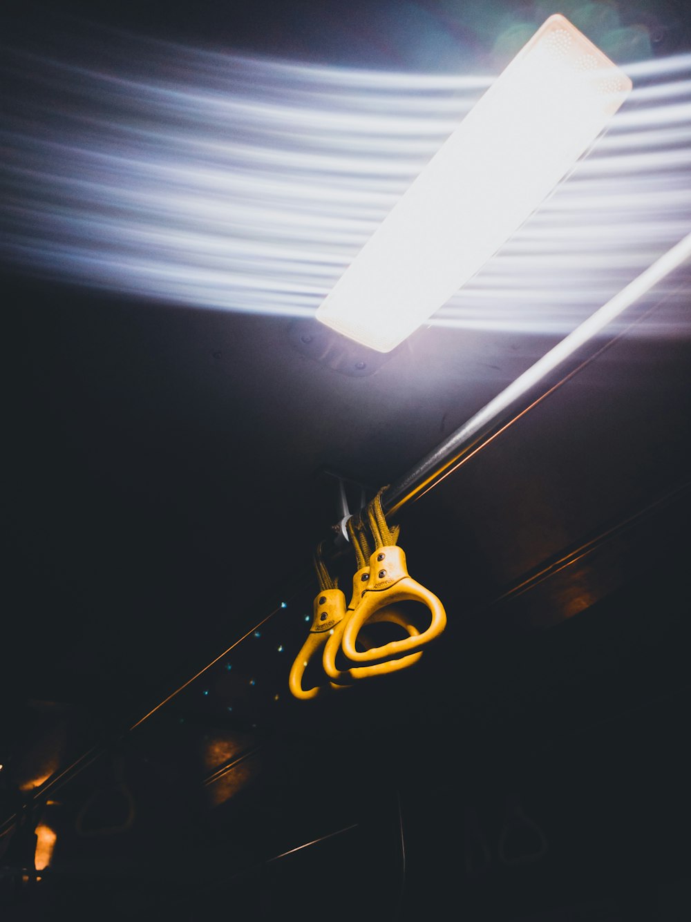 a yellow object hanging from a ceiling in a dark room