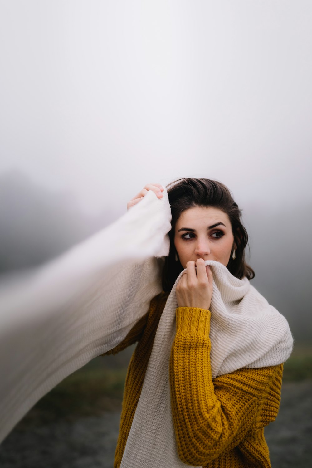 woman wearing orange sweater and white scarf