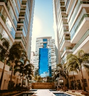 low-angle photography of two white high-rise buildings