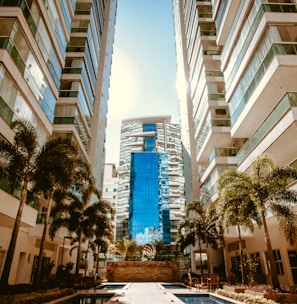 low-angle photography of two white high-rise buildings