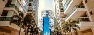 low-angle photography of two white high-rise buildings