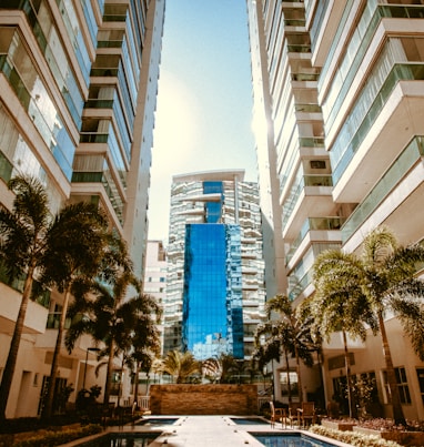 low-angle photography of two white high-rise buildings