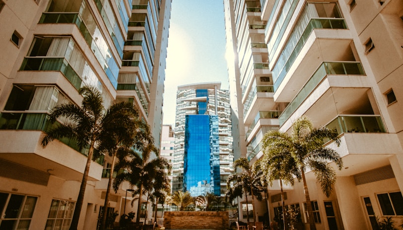 low-angle photography of two white high-rise buildings