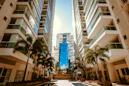low-angle photography of two white high-rise buildings