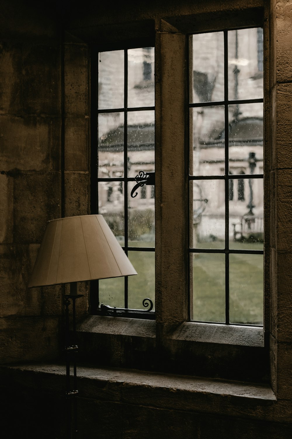 beige table lamp near window