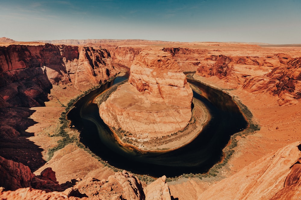 aerial photography of rock formation on lake surrounded by rock