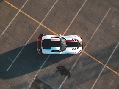 white and black car on paved road