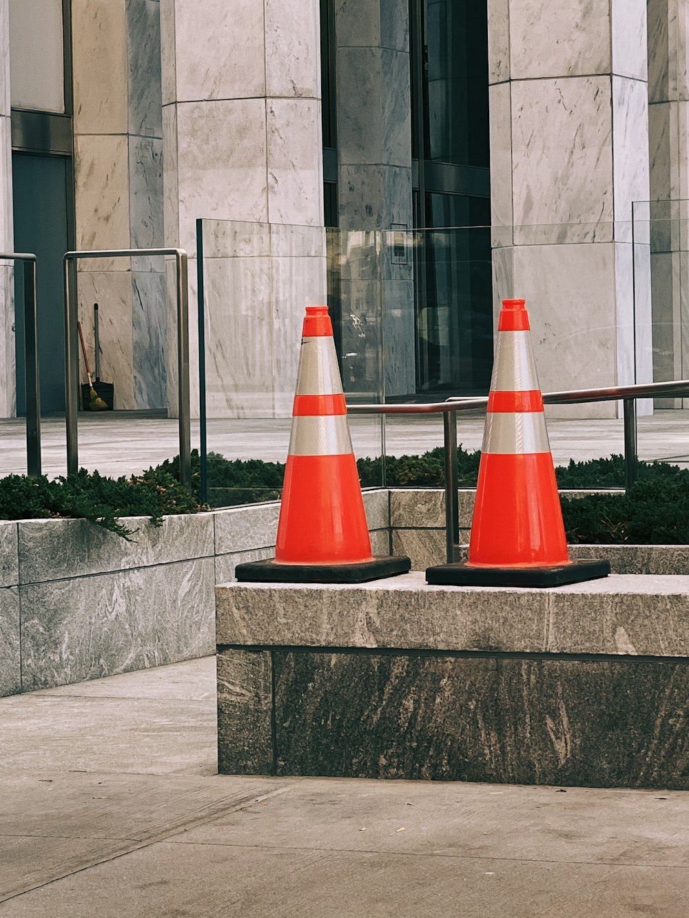 two red-and-white traffic cones