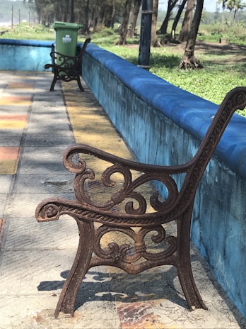 Custom iron furniture pieces including a bench and table with decorative iron legs.