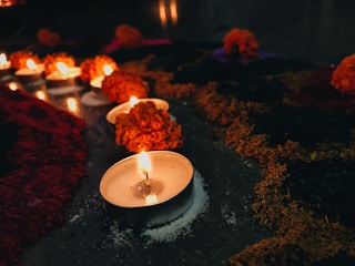 Colorful candles with floral decorations in soft lighting.
