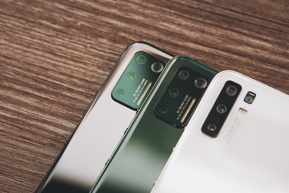 two samsung phones side by side on a wooden surface